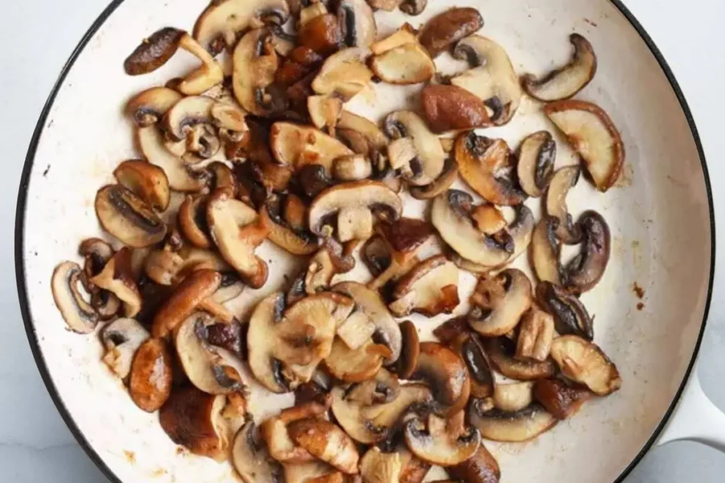 Sautéed white button mushrooms, perfectly browned and caramelized, ready to be added to Outback Steakhouse Alice Springs Chicken.